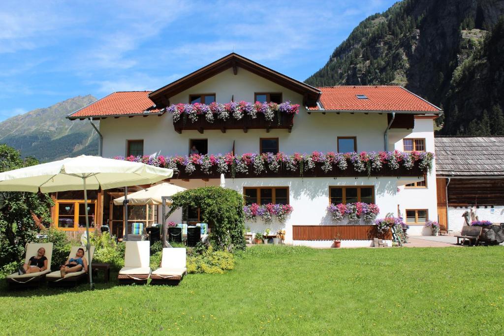 a house with flowers on the side of it at Haus Renate in Kaunertal