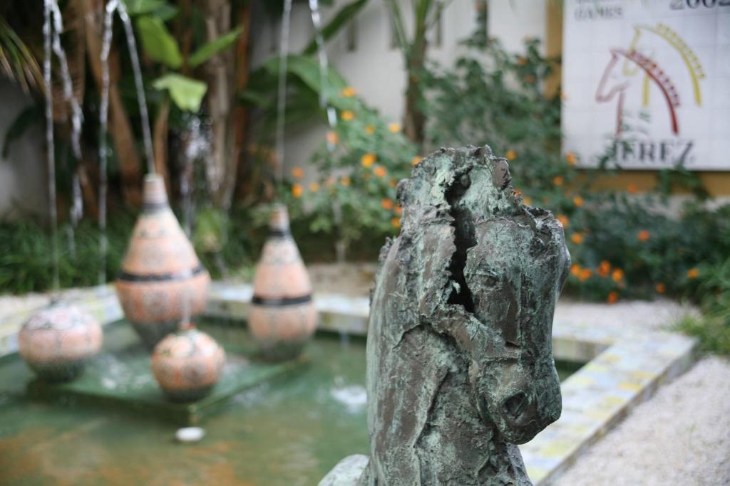 a statue of a dog in front of some vases at Hotel Jerez &amp; Spa in Jerez de la Frontera