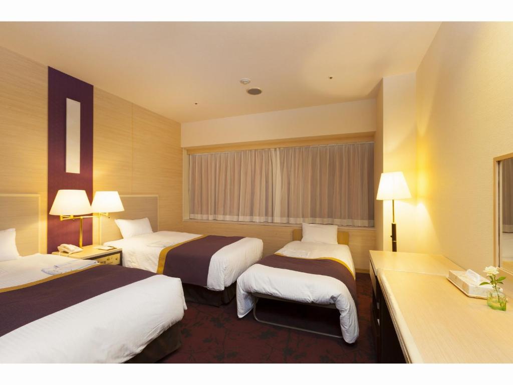 Postel nebo postele na pokoji v ubytování Chofu Creston Hotel