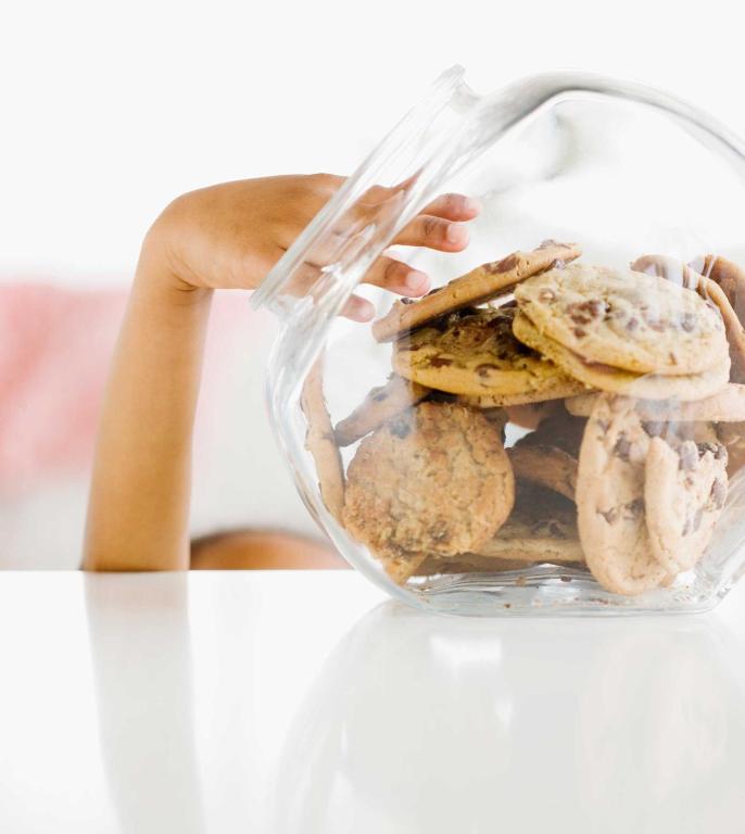 a person holding a glass container filled with cookies at Country Inn & Suites by Radisson, Pensacola West, FL in Pensacola