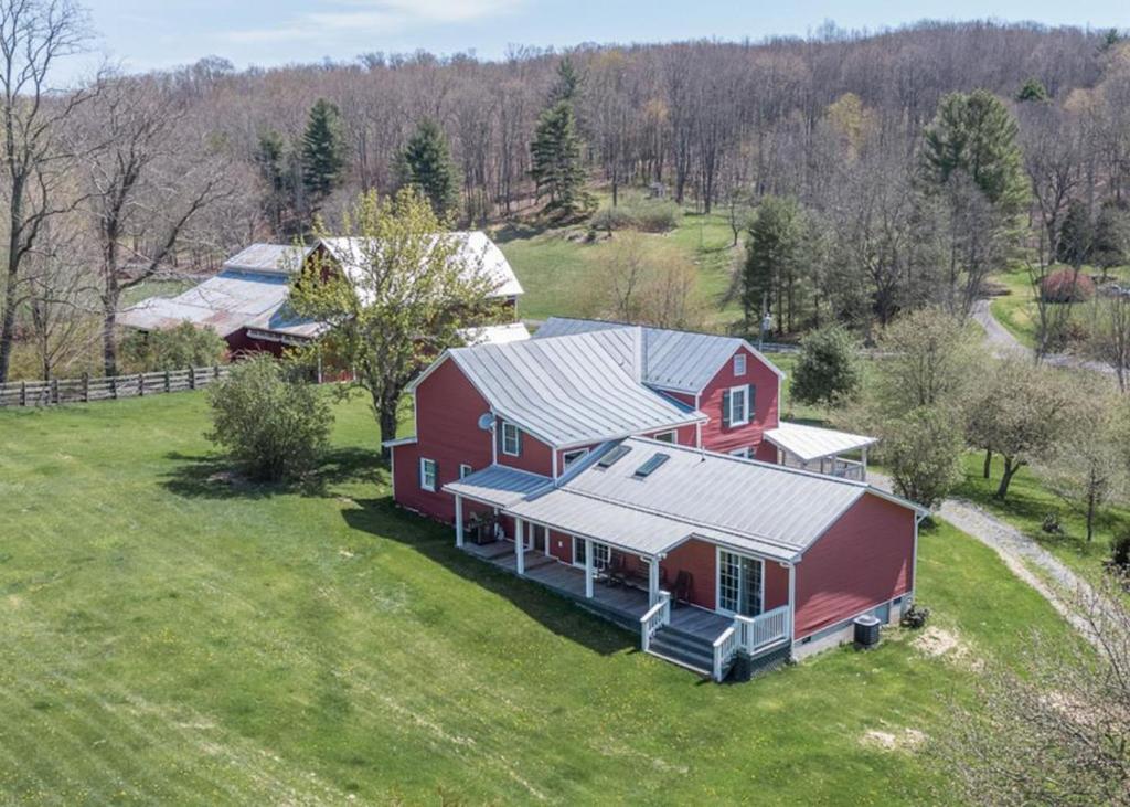 an aerial view of a red barn on a field at Cold Spring Farm in Williamsville