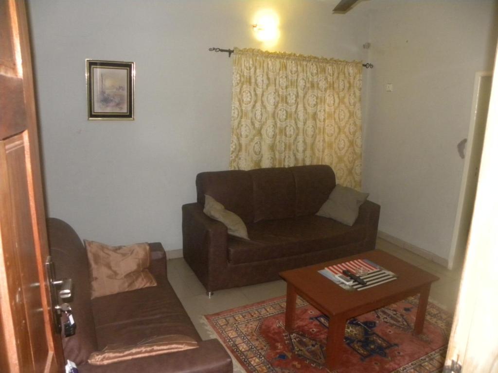 a living room with a couch and a coffee table at Biso Inn in Alimosho