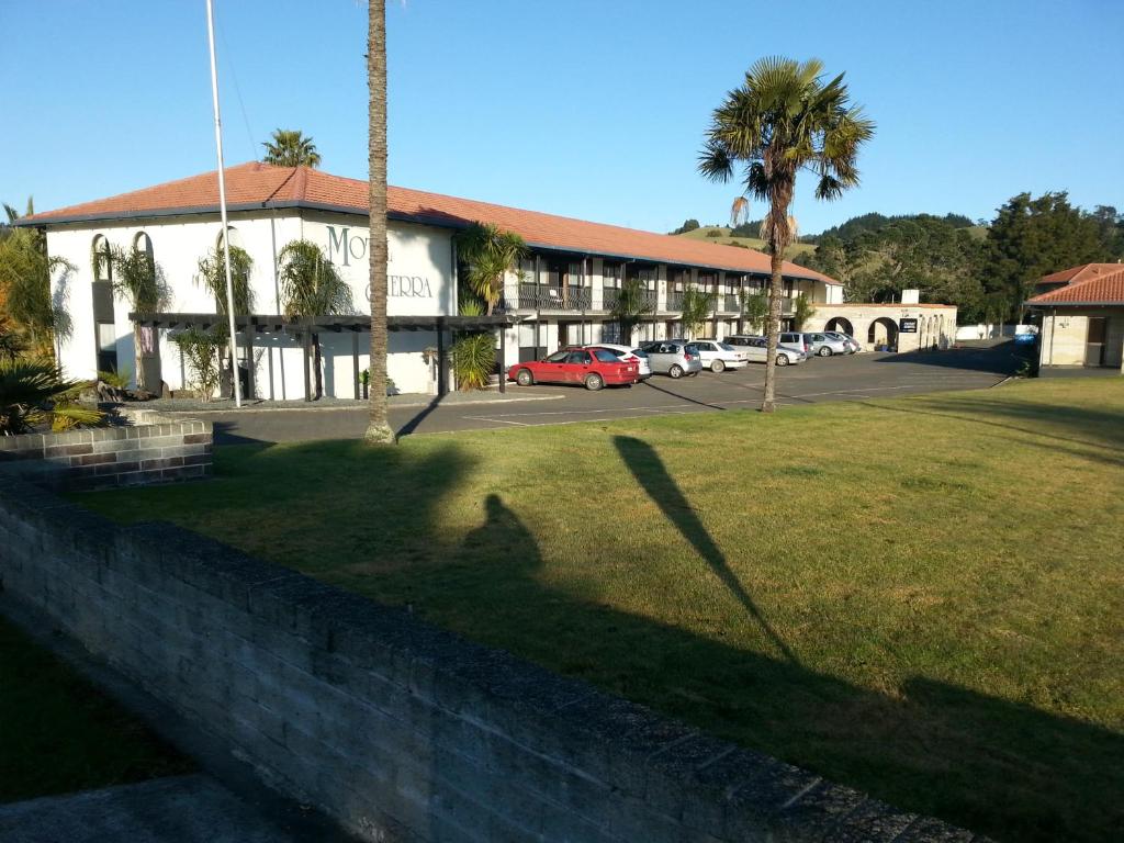 a shadow of a person on a wall in front of a building at Motel Sierra in Whangarei