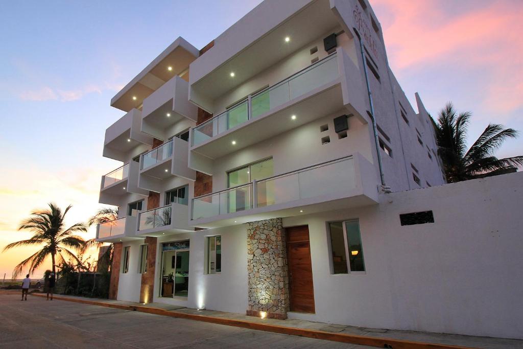 a large white building with a view of the ocean at Hotel Casa Pridda in Puerto Escondido