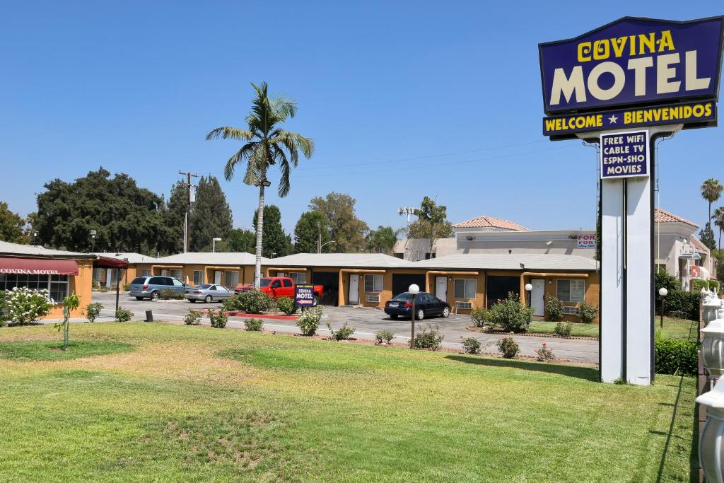 a motel sign in front of a parking lot at Covina Motel in West Covina