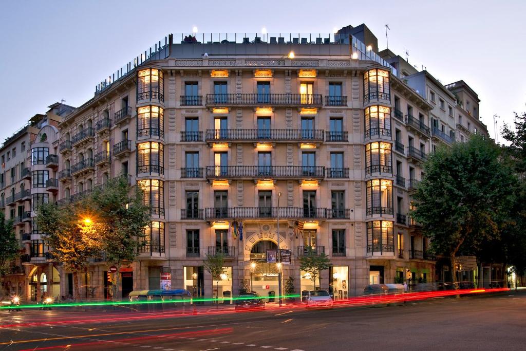 a large building on a city street at night at Axel Hotel Barcelona - Adults Only in Barcelona
