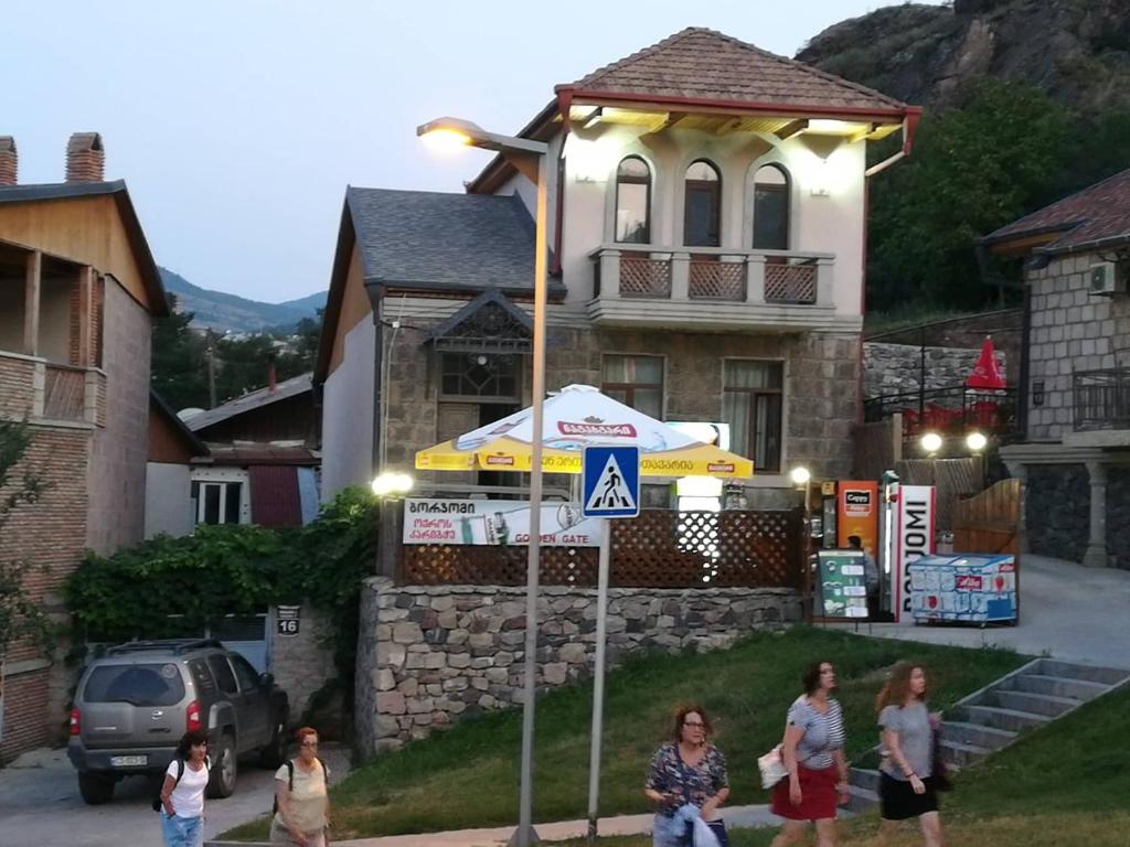 a group of people standing in front of a house at Golden Gate in Akhaltsikhe