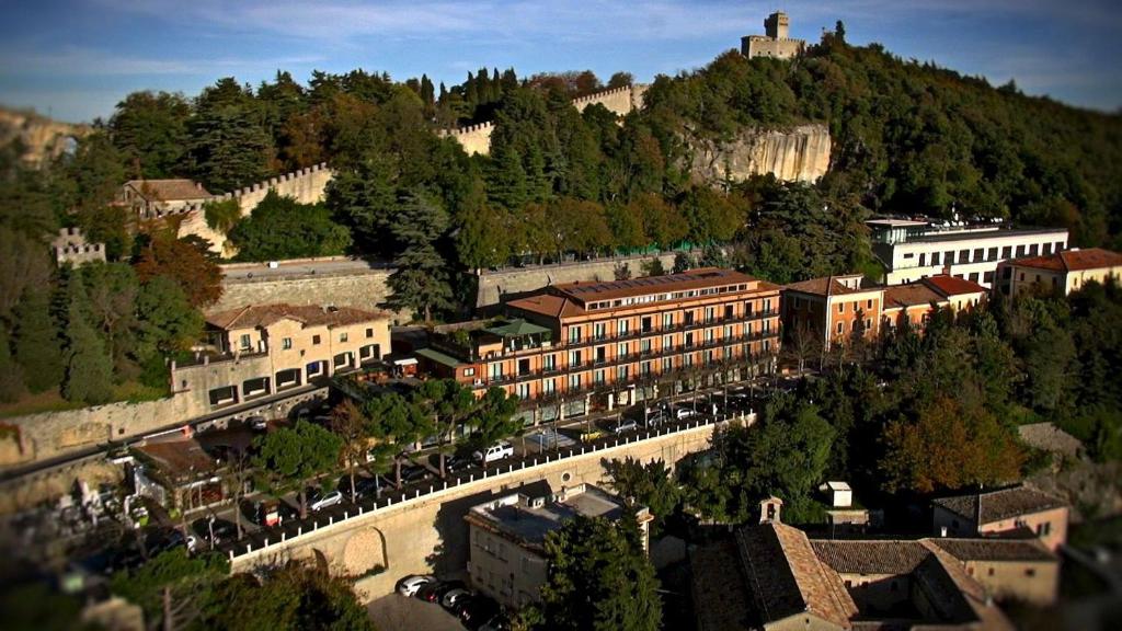 a view of a town with a castle on a mountain at Grand Hotel San Marino in San Marino