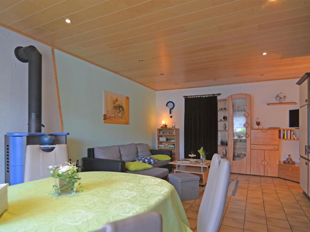 a living room with a table and a couch at Modern Apartment in Niedersfeld with Sauna in Winterberg