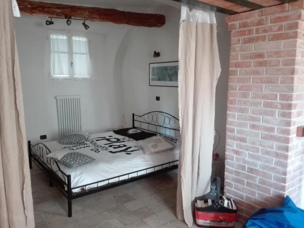 a bedroom with a bed and a brick wall at YHouse 33 in Trento