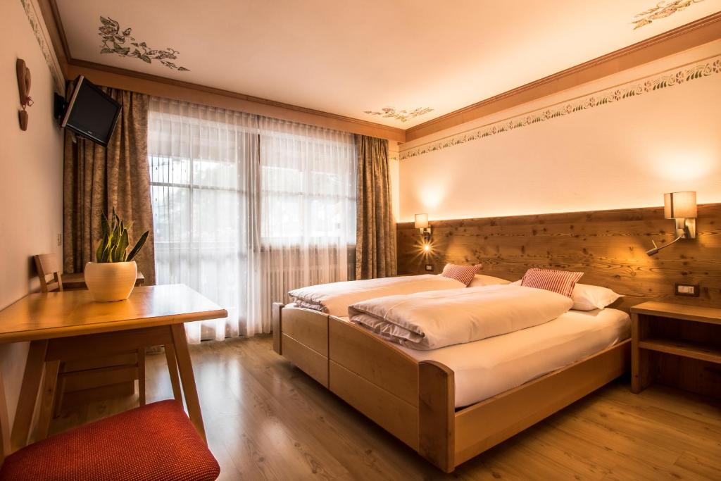 Postel nebo postele na pokoji v ubytování Ciasa Montanara