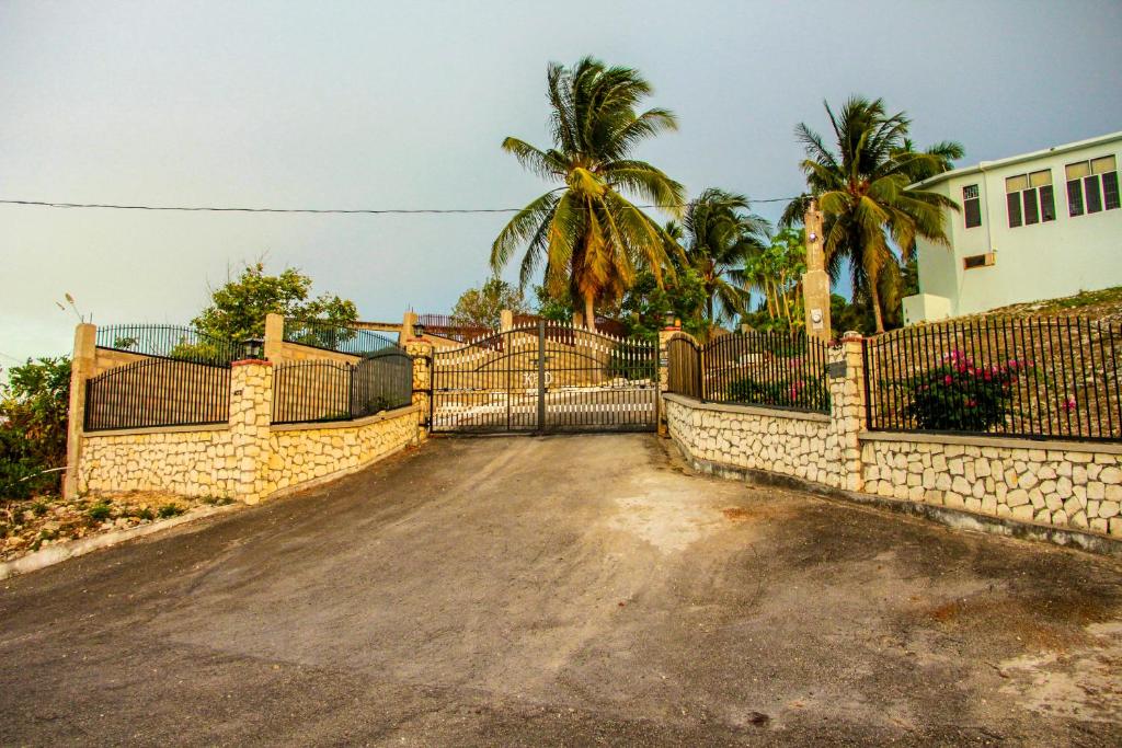 una puerta en una entrada con una valla en Sunshine Lodge: Your home away from home en Montego Bay