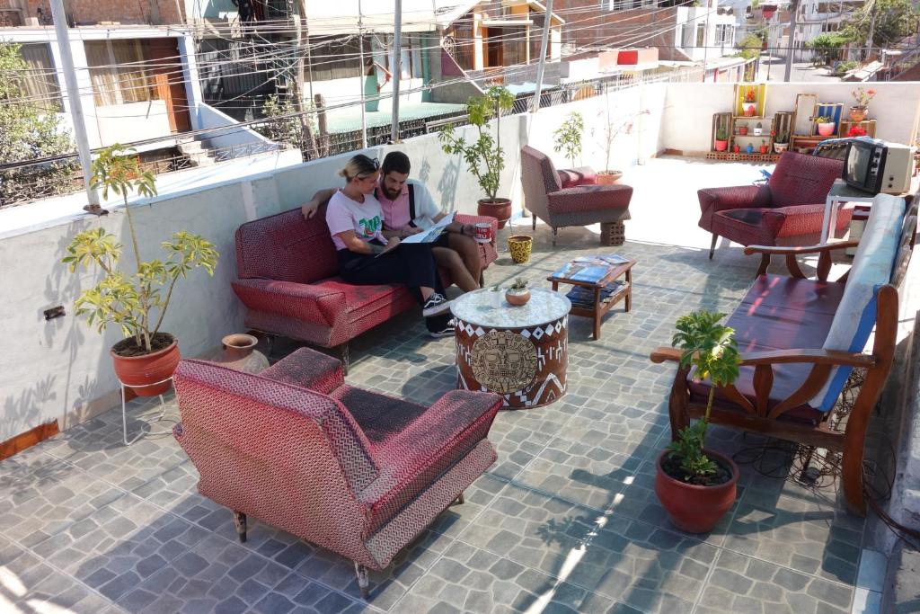 a couple of people sitting on a patio at La Casa de Chamo in Arequipa