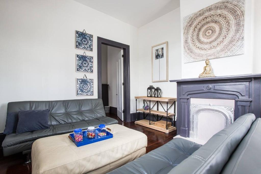 a living room with a couch and a fireplace at New Orleans Hideaway in New Orleans