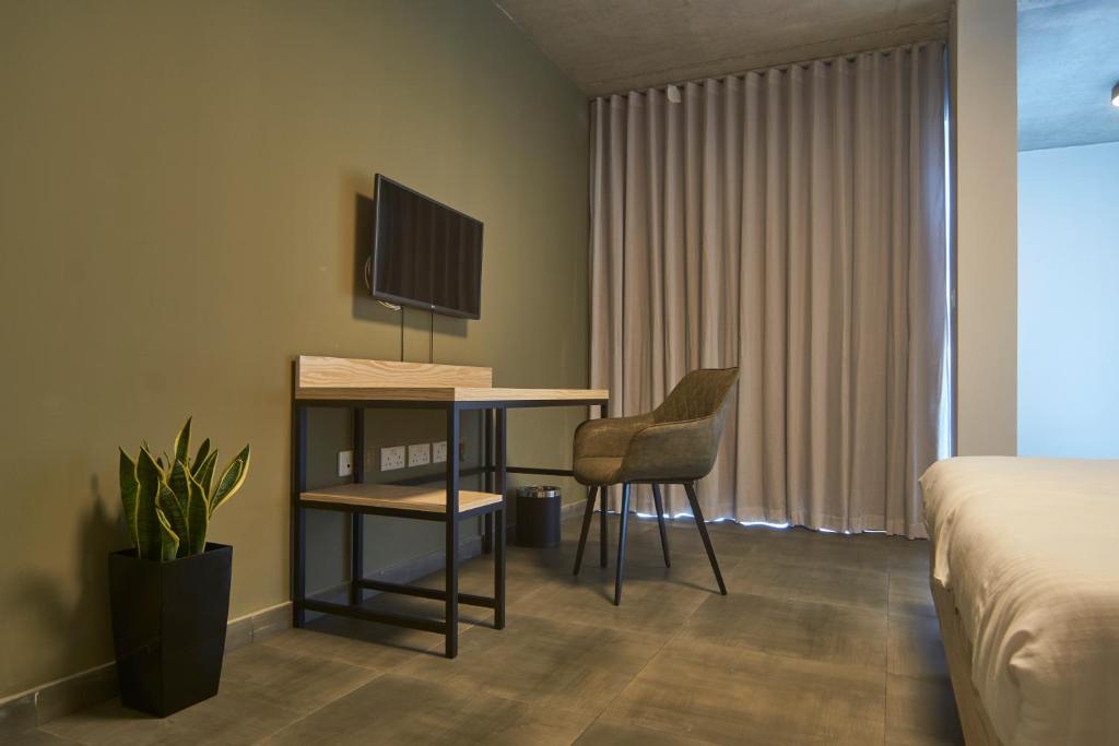 Postel nebo postele na pokoji v ubytování Mr Todd Hotel