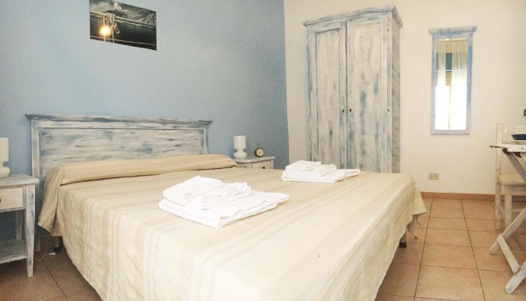 a bedroom with a bed with two towels on it at Blu Rooms Marettimo in Marettimo