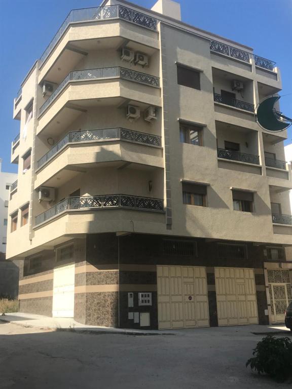 a tall building with balconies on the side of it at Tanger Jenane Marjane in Tangier