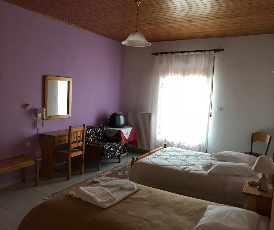 Postel nebo postele na pokoji v ubytování Hotel Antigoni