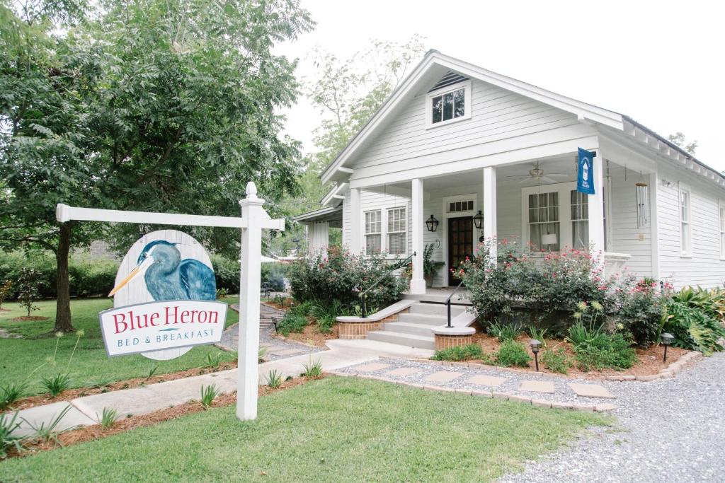 a house with a blue hen sign in front of it at Blue Heron B&B in Mandeville
