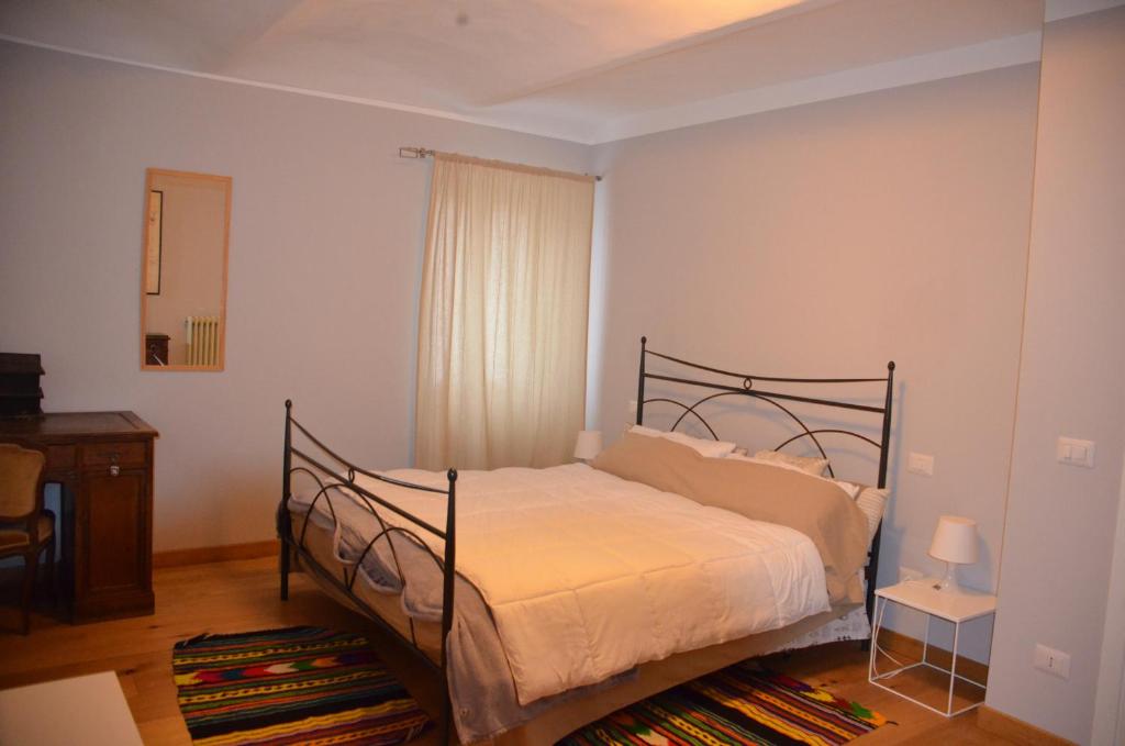 a bedroom with a bed and a dresser and a window at cascina Filura in Mango