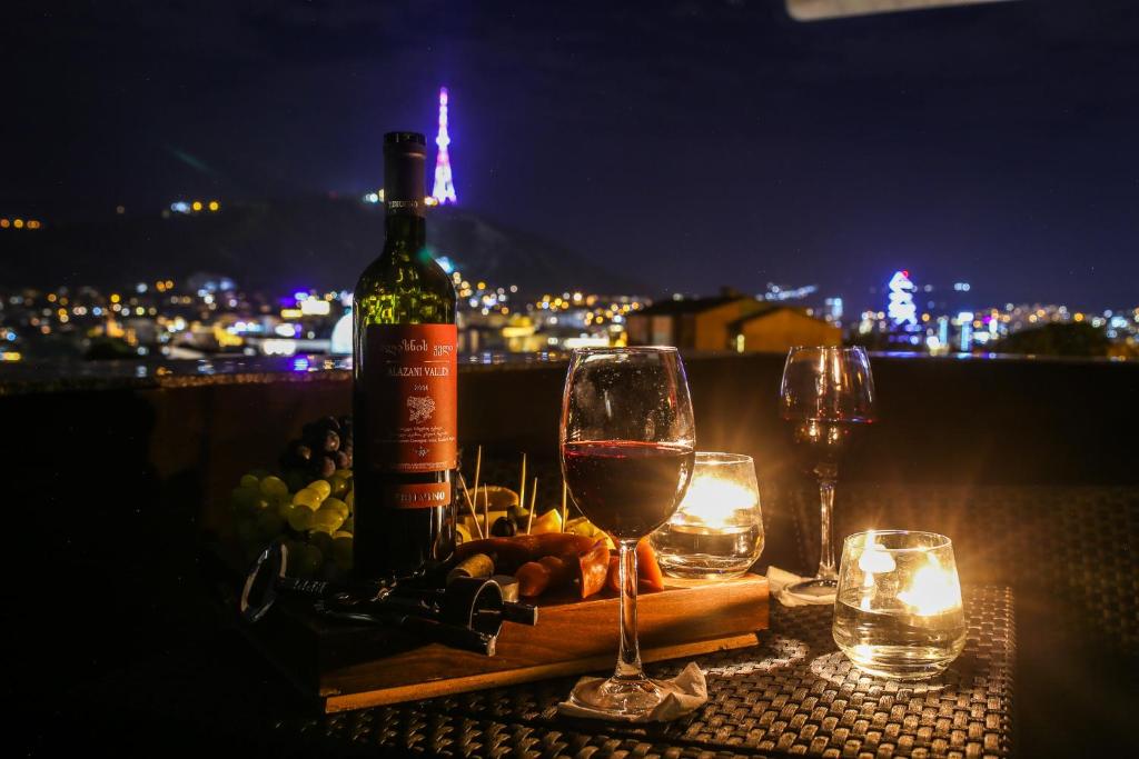 a bottle of wine sitting on top of a table at Grand Hotel Mimino in Tbilisi City