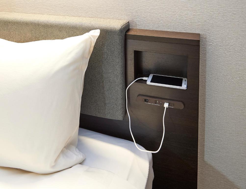 Postel nebo postele na pokoji v ubytování Hotel Consort Shin-Osaka