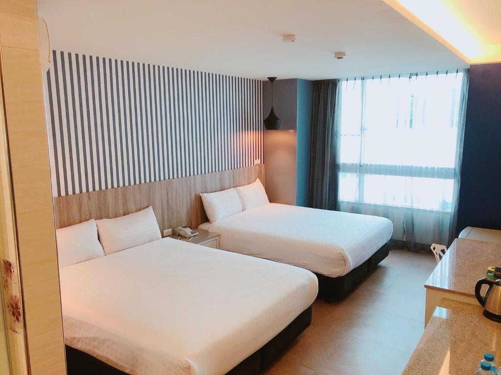 Postel nebo postele na pokoji v ubytování P&E Hotel