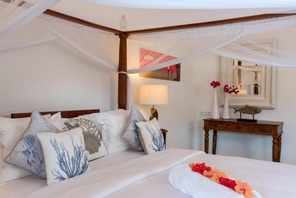 Postel nebo postele na pokoji v ubytování Tikitam Palms Boutique Hotel