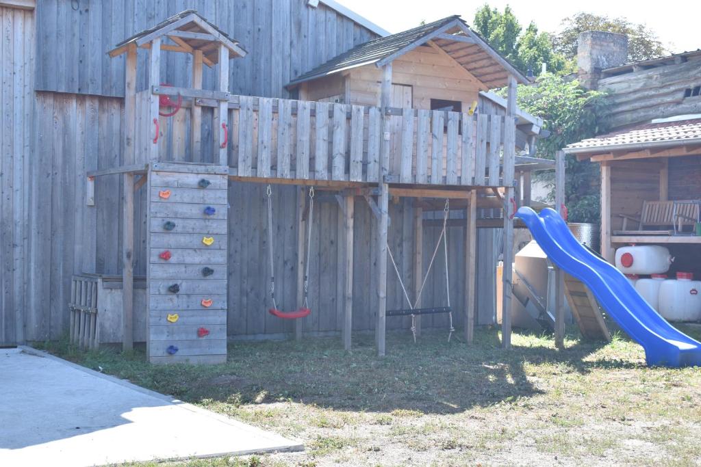 a playground with a slide and a play house at Apfelhof Biesenbrow in Biesenbrow