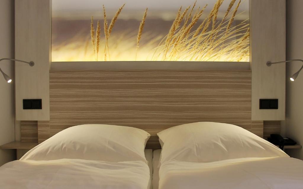 Postel nebo postele na pokoji v ubytování Hotel Strandhof