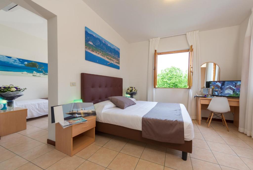 Postel nebo postele na pokoji v ubytování Hotel La Pace