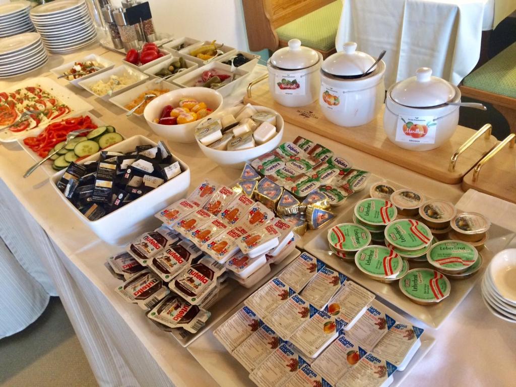 a buffet with many different types of food on a table at Hotel Garni Wurzer in Velden am Wörthersee