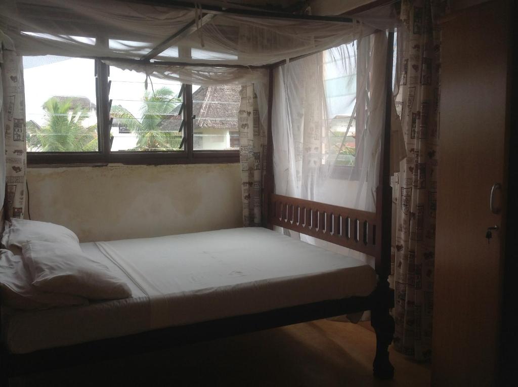 Postel nebo postele na pokoji v ubytování Jannataan Hotel