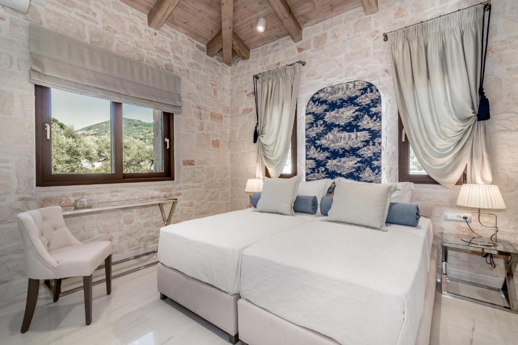 A bed or beds in a room at Porto Vasilikos Villas