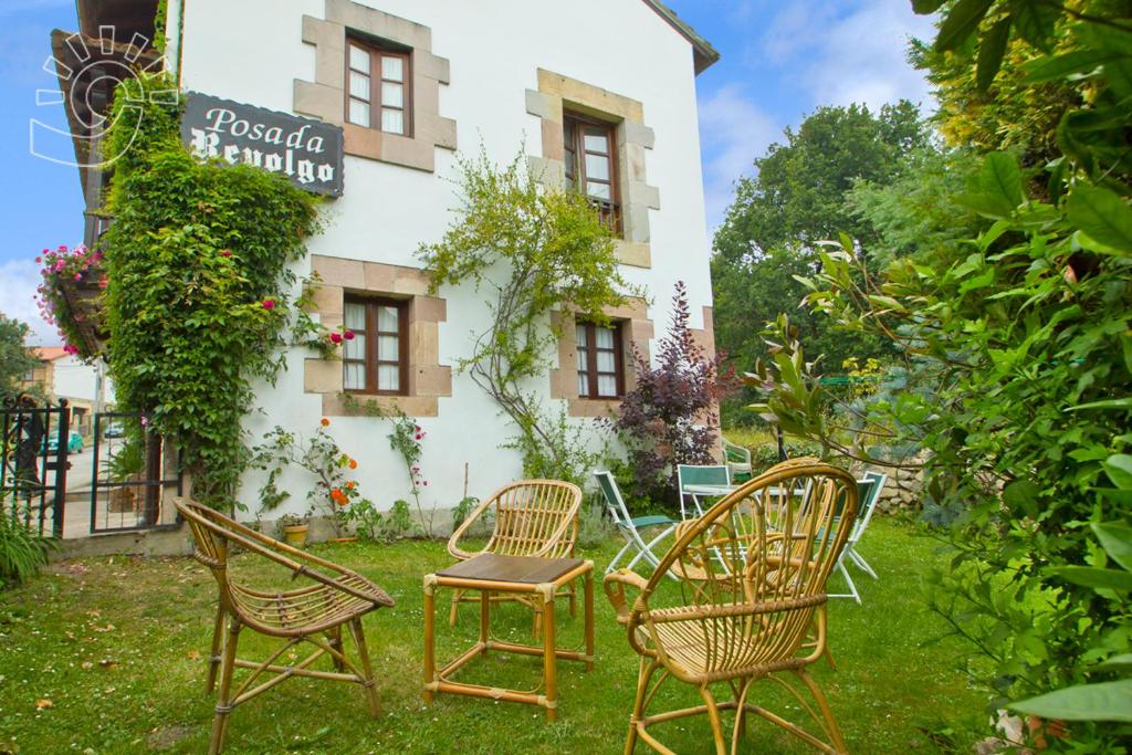 a group of chairs in front of a building at Posada Revolgo in Santillana del Mar