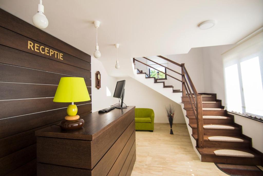 a room with a desk with a lamp and stairs at Casa Anastasia in Vişeu de Sus