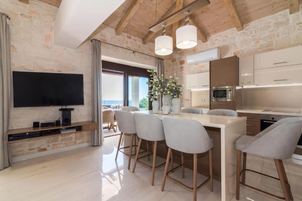 A kitchen or kitchenette at Porto Vasilikos Villas