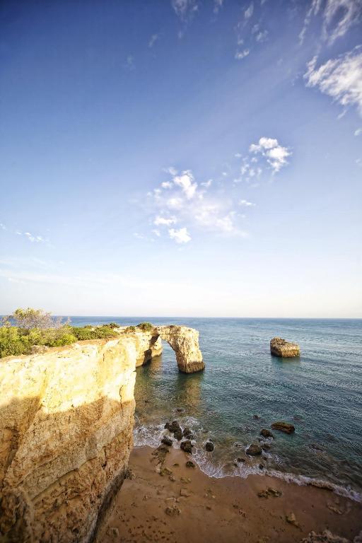 two large rocks in the ocean next to the shore at Vila Alba Resort in Carvoeiro