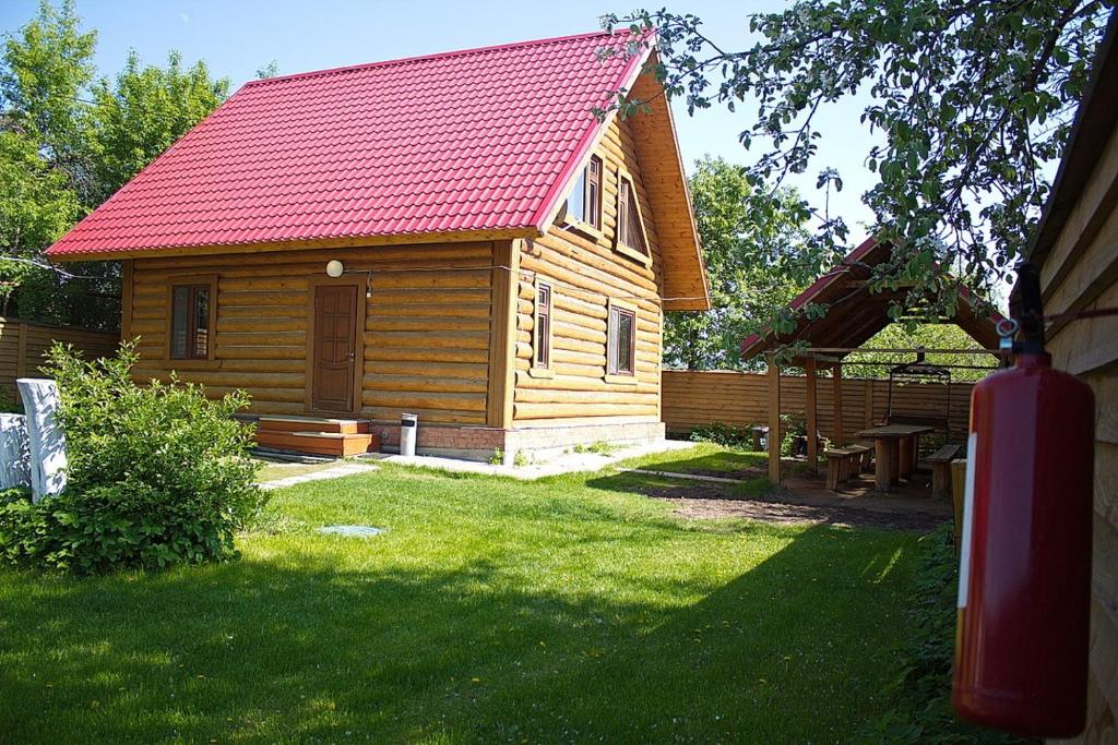 a small wooden cabin with a red roof at Cottage Club Nagornyy in Kazan