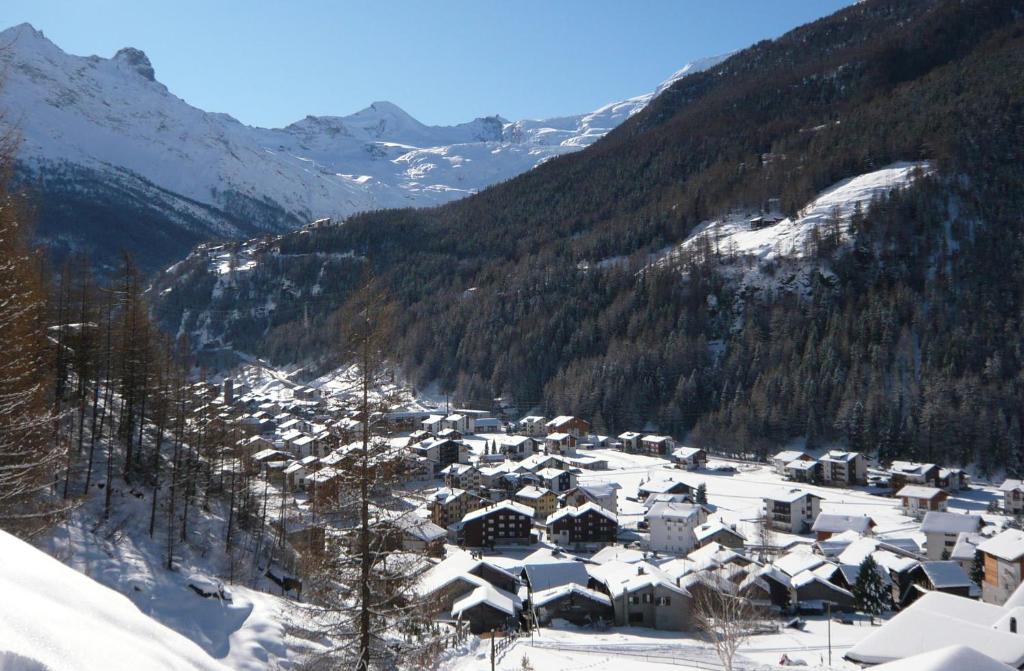a small village covered in snow in a mountain at Sunshine in Saas-Grund