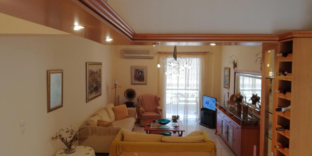 a living room with two couches and a tv at Apartment Giorgos kalamata in Kalamata