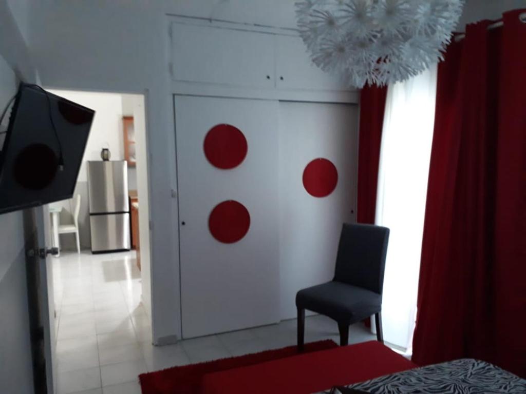 a room with a chair and a door with red circles at Isla Verde Apt Two-Bedroom in San Juan