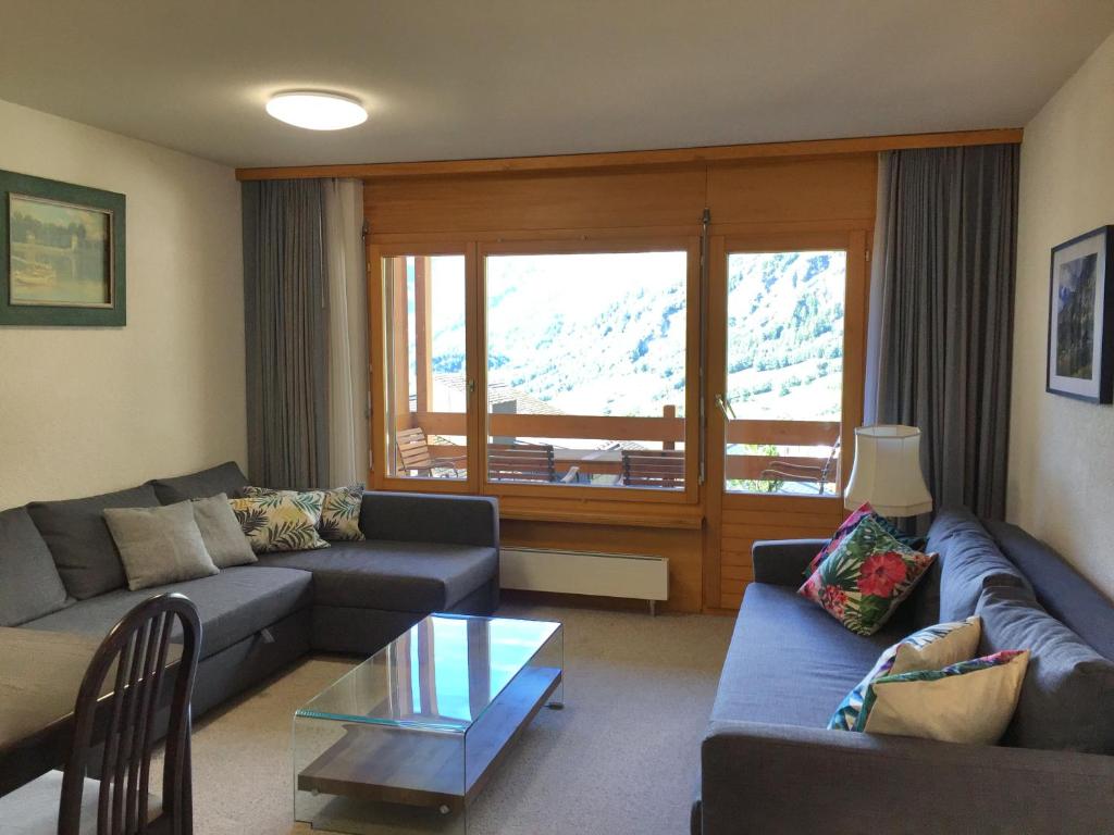 a living room with a couch and a table at Haus Rothorn, Swiss Alps in Leukerbad