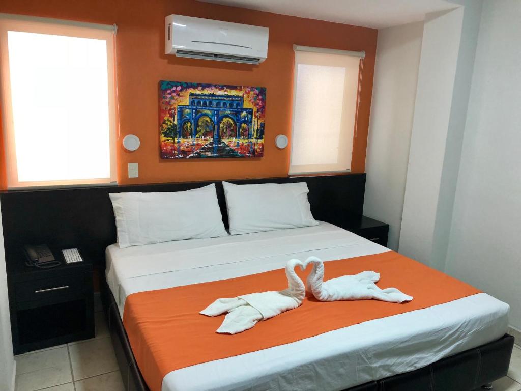 Postel nebo postele na pokoji v ubytování Hotel Belisario INN