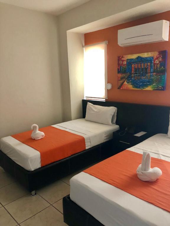 Postel nebo postele na pokoji v ubytování Hotel Belisario INN