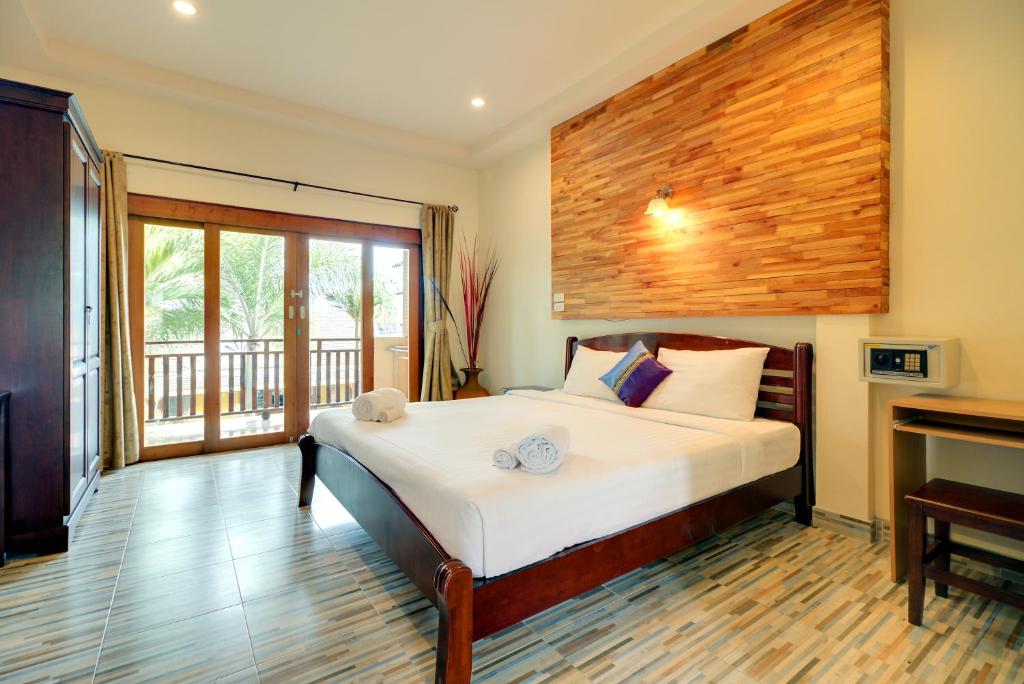 a bedroom with a bed and a fireplace at The Bulin Residence in Lamai