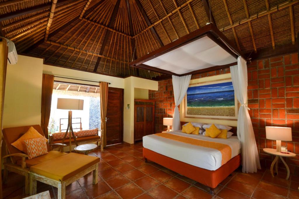 Postel nebo postele na pokoji v ubytování Taman Sari Bali Resort and Spa