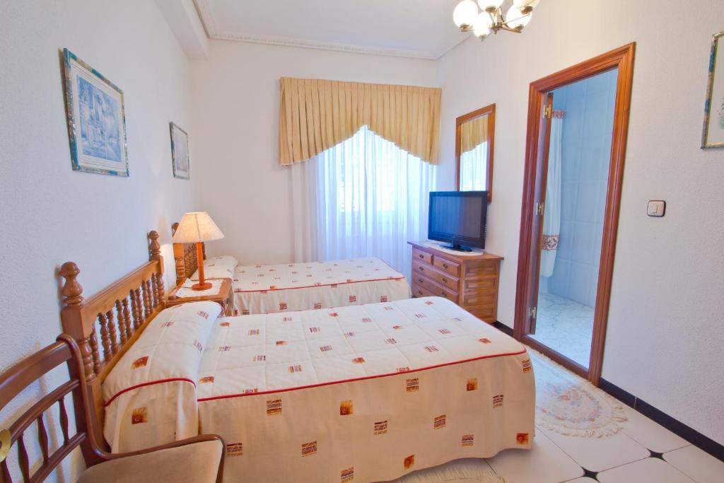 A bed or beds in a room at Hospedaje Roiz