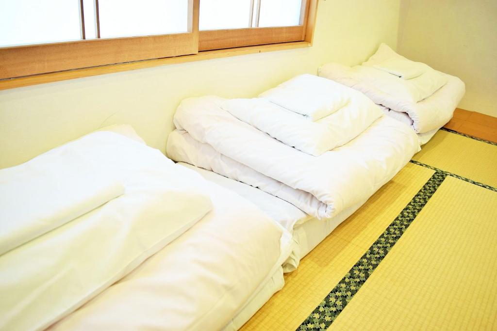 Postel nebo postele na pokoji v ubytování Hiroshima Hostel EN
