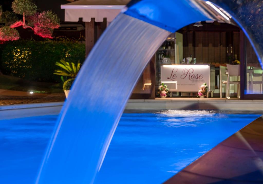 a water slide in front of a swimming pool at Le Rose in Nettuno